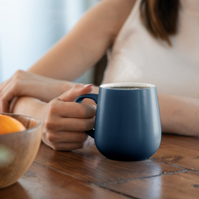 woman holding ohom mug