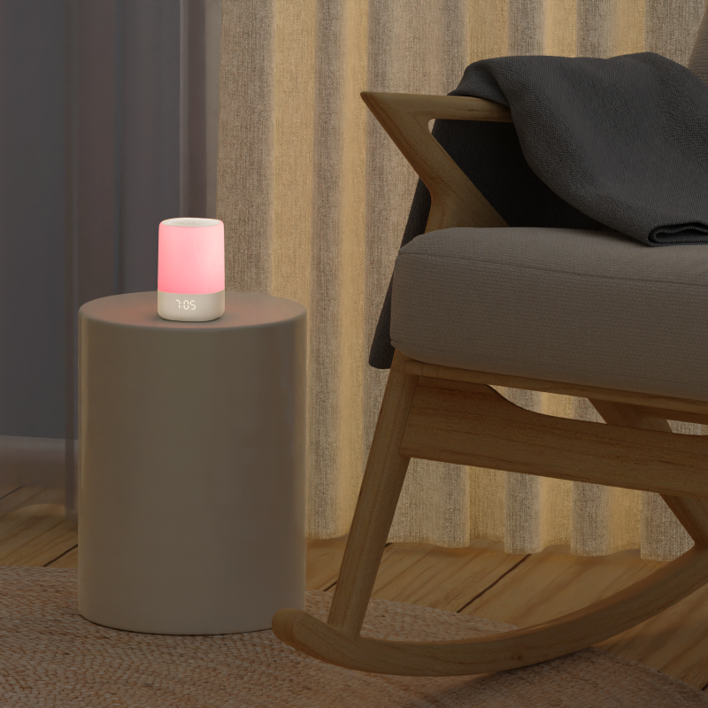 lifestyle image of sound and light in pink light on a side table